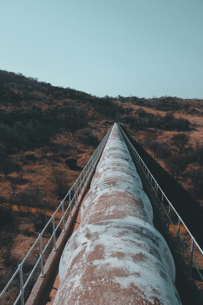 Aging pipeline infrastructure showing corrosion and weathering in remote location
